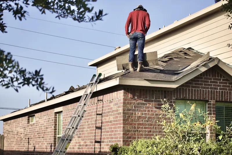 Professional roofer working on a residential roof in North Side
